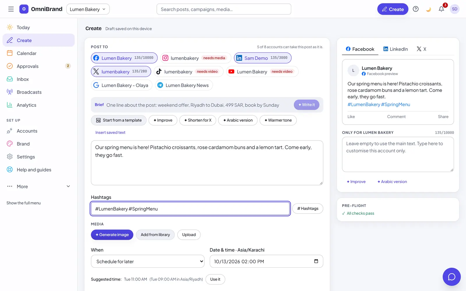 The OmniBrand Create screen: one post for a bakery going to Facebook, LinkedIn and X, with the Facebook preview, the passed pre-flight checks, hashtags, the schedule and the suggested best time.